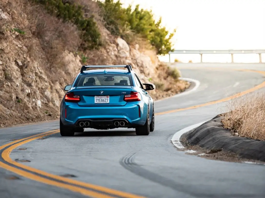 rear view of car driving down curvy road in California