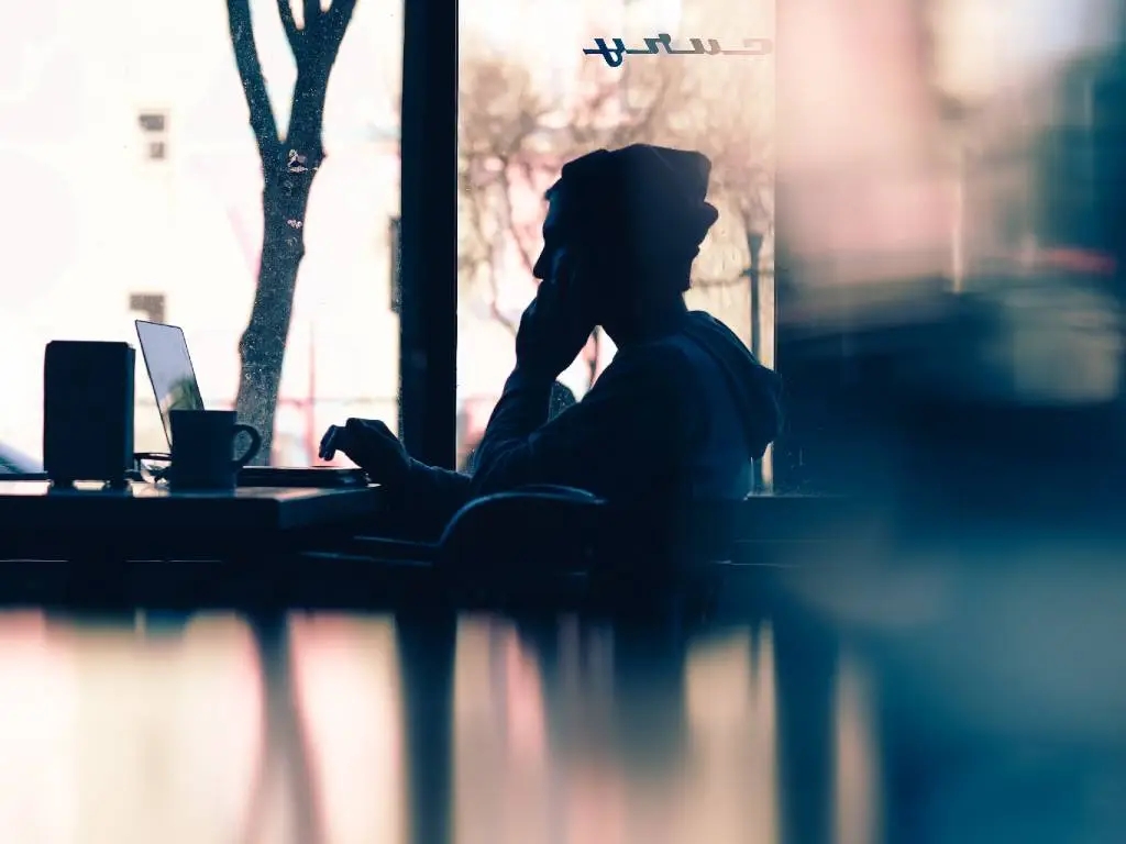 man on phone in coffee shop