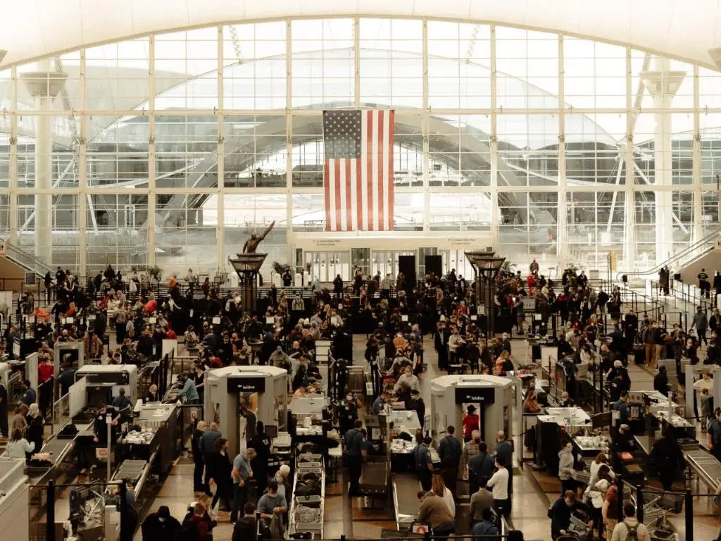 Crowded airport filled with people.